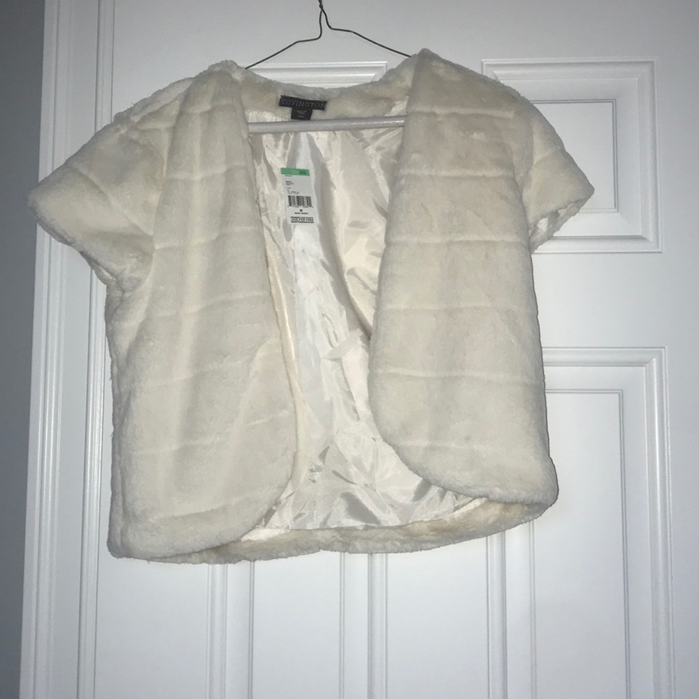White fuzzy vest.